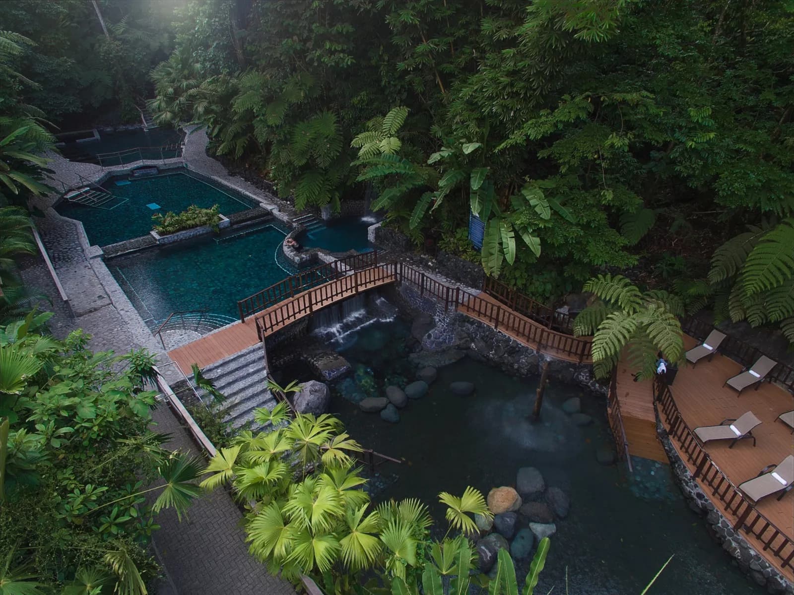 Hikers below Arenal Volcano on day one Thermal pools seen from above at Ecotermales
